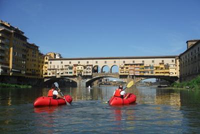 Kayak on the Arno river in Florence under the Old Bridge Kayak on the Arno river in Florence under the Old Bridge