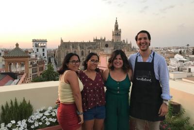 Cooking Paella on a Rooftop with Cathedral of Seville View